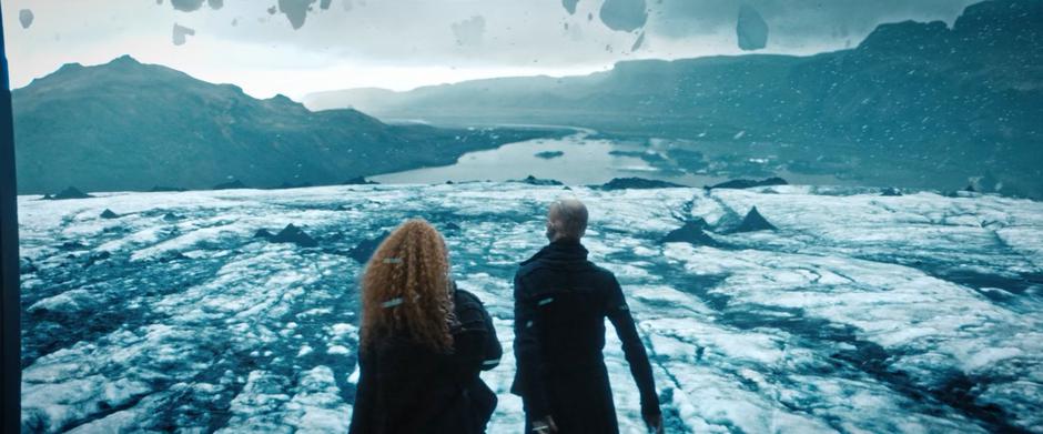 Tilly and Saru exit the Discovery and walk across the glacier.