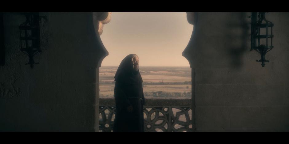 Adriel stands on a balcony of the castle looking older.