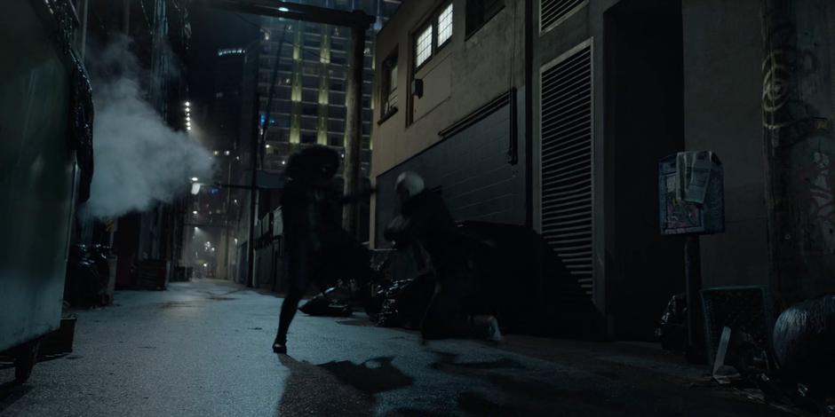 Ryan kicks Victor Zsasz and they fight in the dark alley.