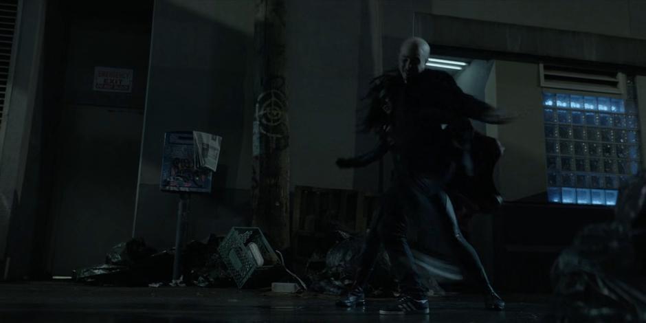Victor Zsasz jumps and knocks Ryan to the ground.