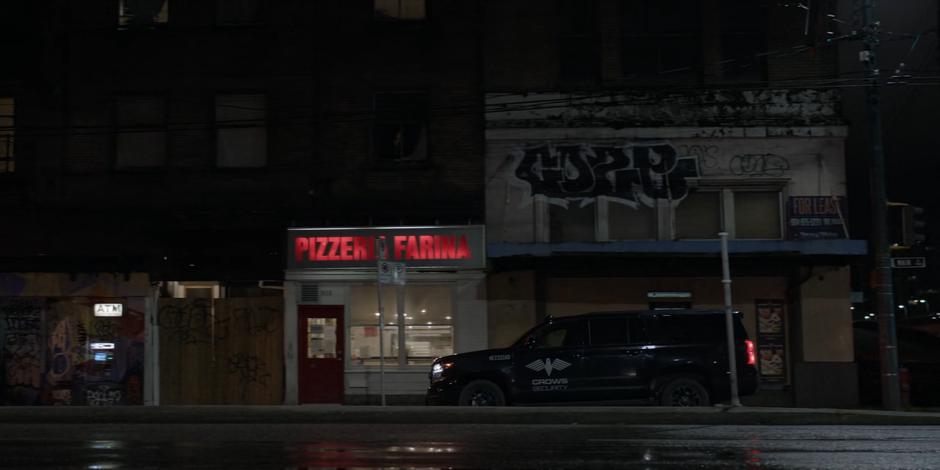 Sophie parks her Crows Security vehicle in front of the pizzeria.