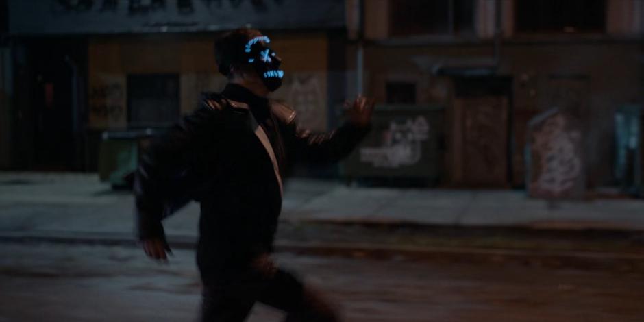 A masked False Face Society dealer run down the street.