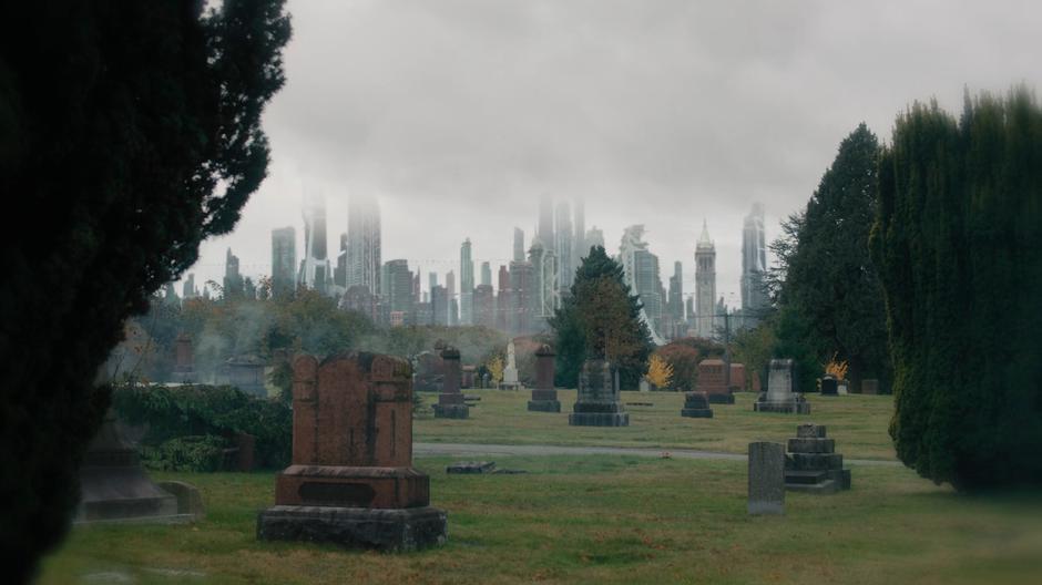 Futuristic skyscrapers rise in the distance beyond the cemetery.