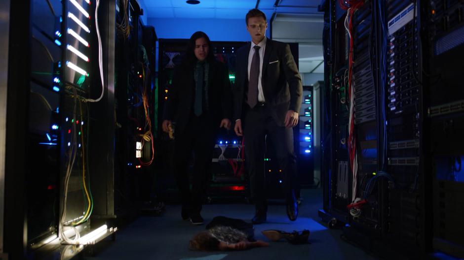 Cisco and Ralph look at Sue's discarded disguise on the floor of the server room.