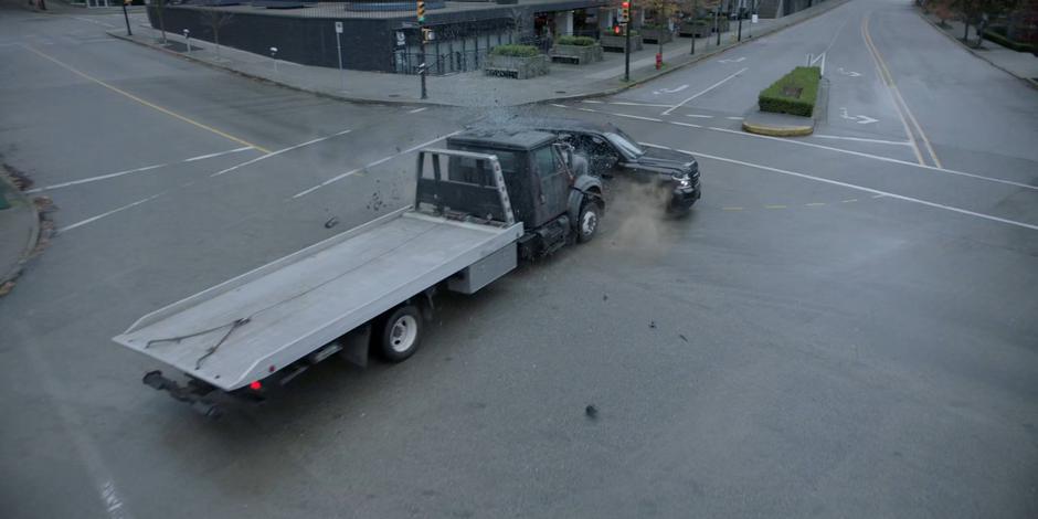 The truck pushes Jacob's SUV across the intersection.