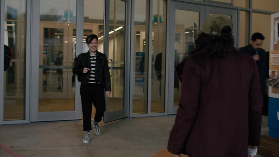 Kevin greets Mel after catching her trying to sneak into the school.