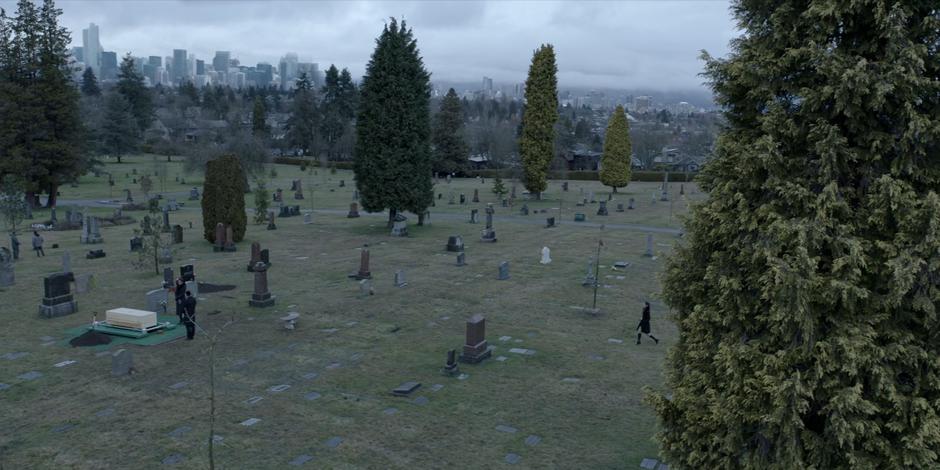 Mary crosses the cemetery to where Sophie and Jacob are waiting beside Kate's grave.