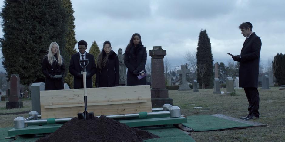 Jacob does a reading over Kate's coffin while Julie, Luke, Mary, and Sophie listen.