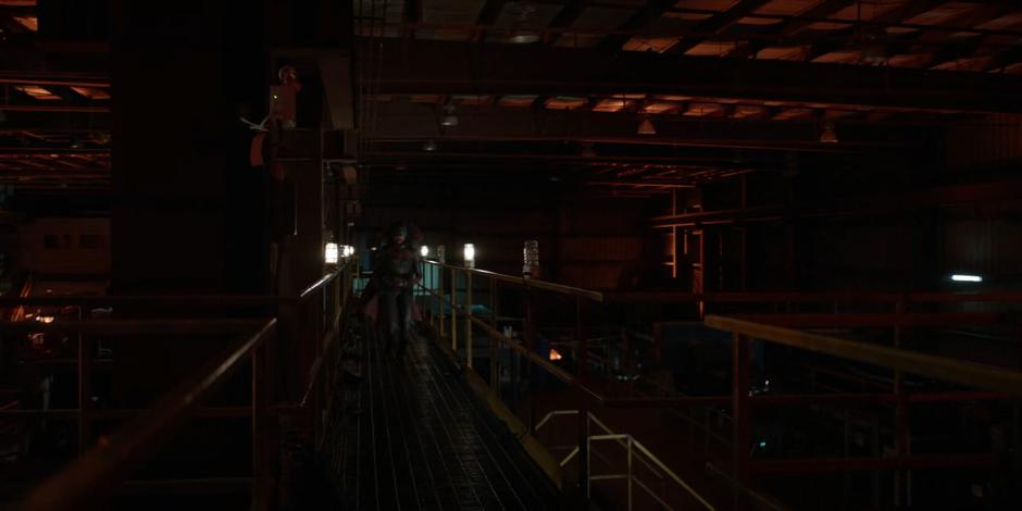 Ryan walks along a catwalk inside the sawmill while searching for Angelique.