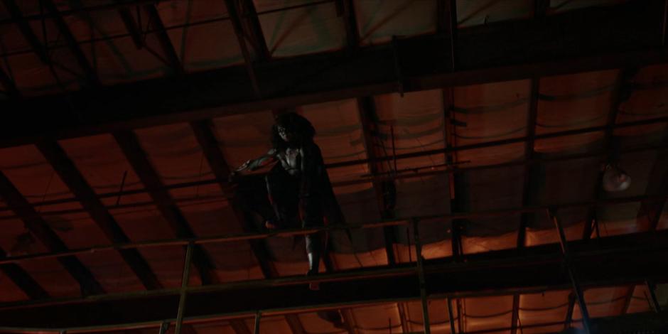 Ryan jumps down from a catwalk when she gets a lead on Angelique's location.