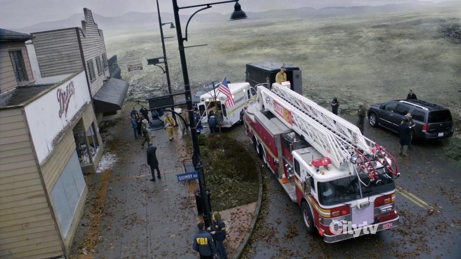 The emergency response team helps the survivors in the center of the destroyed town.