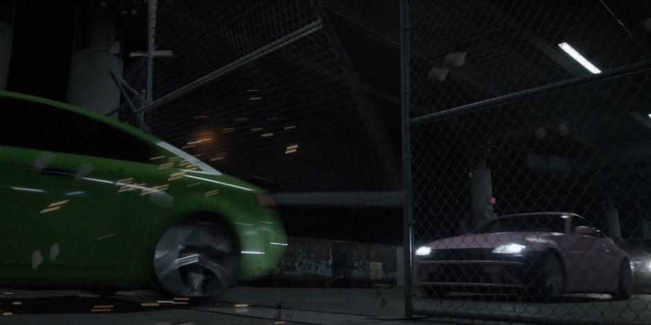 The cars smash through the fence leading to the loading down.