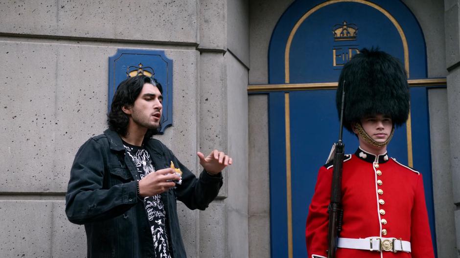 Behrad chats with a stone-faced Queen's Guard.