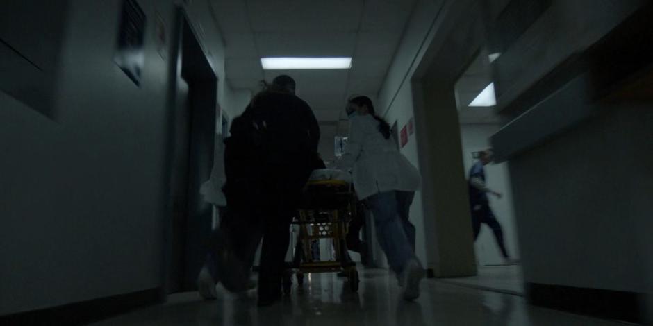 The doctors wheel Luke down the hallway to surgery.