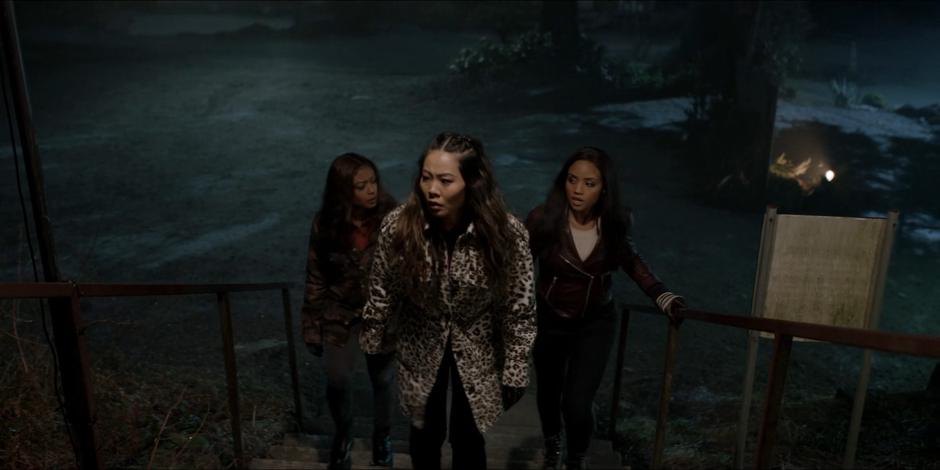 Ryan, Mary, and Sophie walk up the stairs to the shooting range.