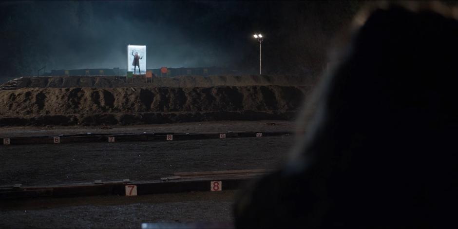 At the far end of the shooting range, Stephanie Brown bangs against the walls of the glass box.