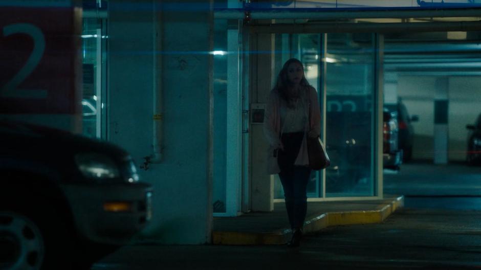 Waverly nervously walks through the parking garage to her car.