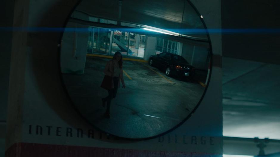 Waverly is visible in a mirror walking to her car.