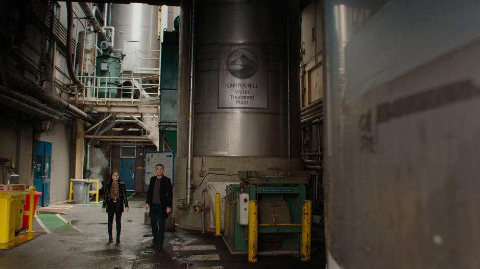Maggie and Harry look around after exiting the portal at the treatment plant.