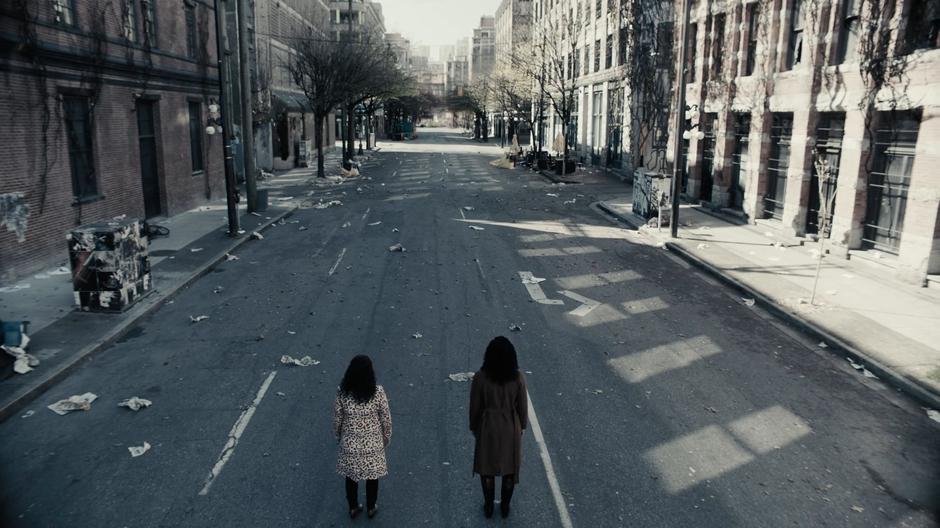 Maggie and Macy stare down the desolate, empty street.