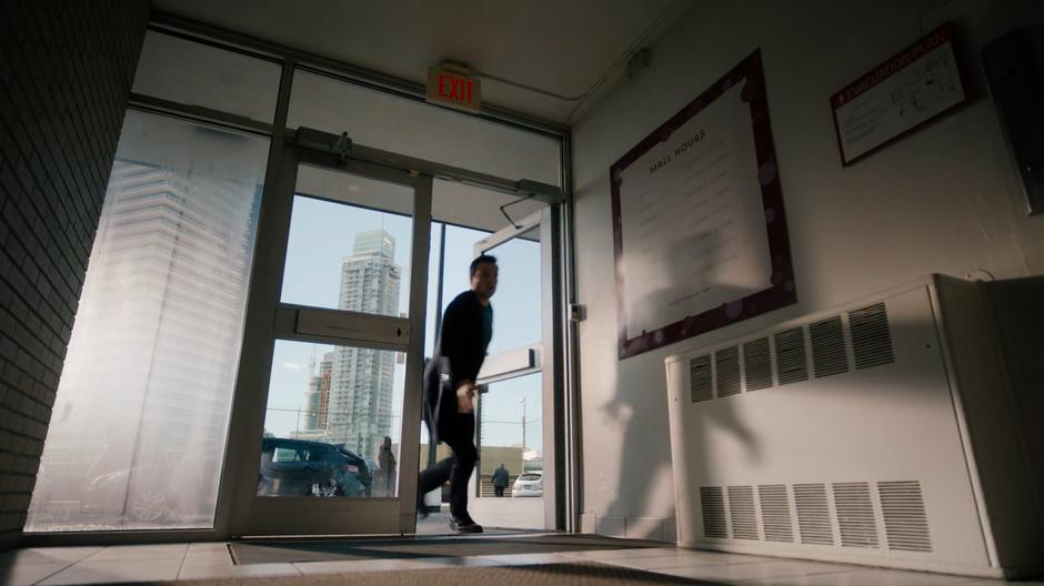 Harry rushes into the parking garage elevator room in the present day.