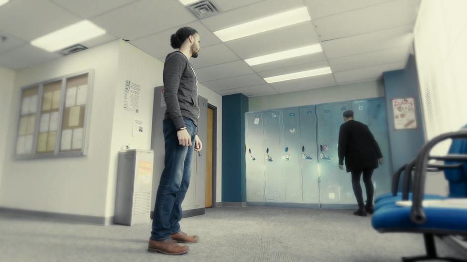 Jordan watches Macy as she examines the magical lockers.