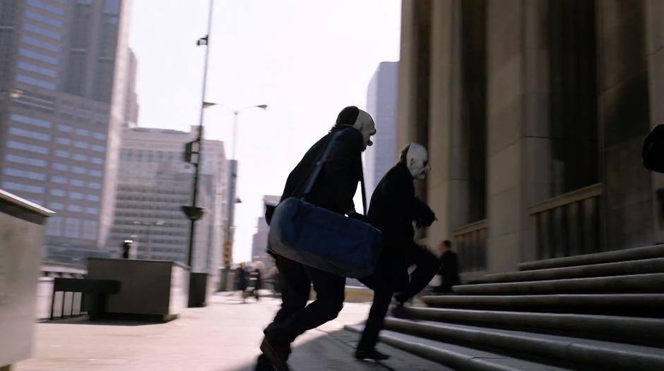 Some of the robbers enter the bank on foot.