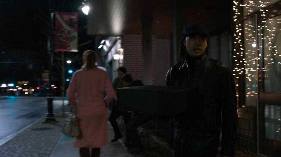 Brainy exits the bakery carrying a box.