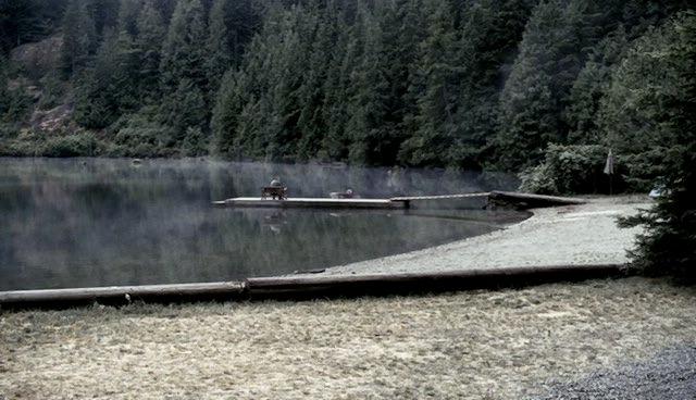 Bill Carlton sits on the dock on the lake.