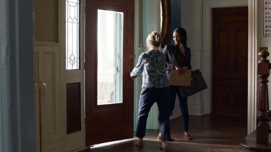 Kelly smiles as Miss Hochschild welcomes her to the home.