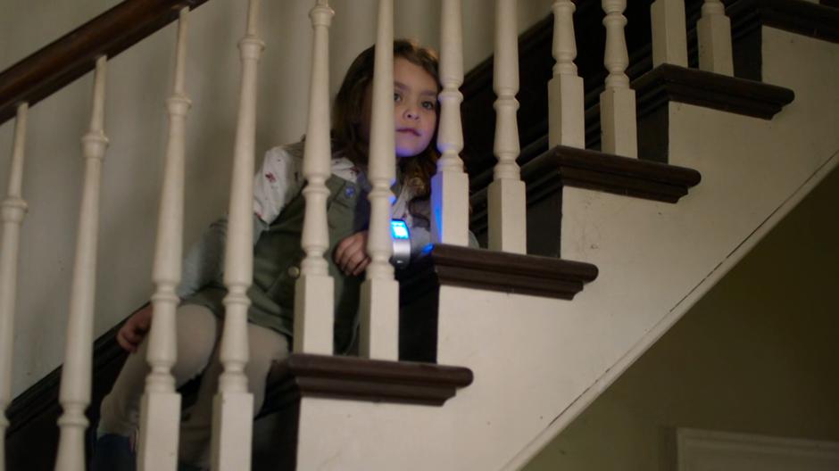 Esme watches from the stairs as Kelly confronts Miss Hochschild.