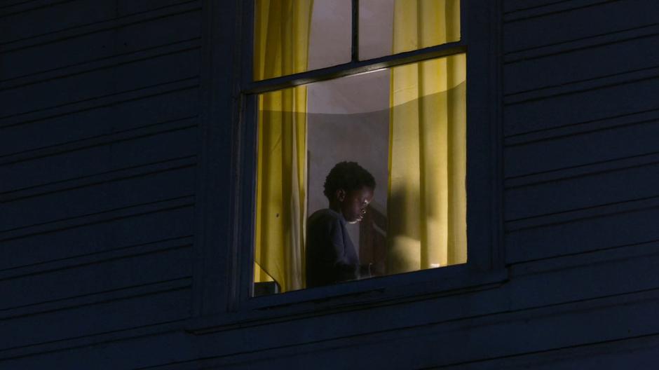 Joey is visible through his window sitting in his room.