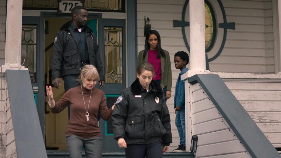 Kelly and Joey watch from the porch as Miss Hochschild is led away by the police.