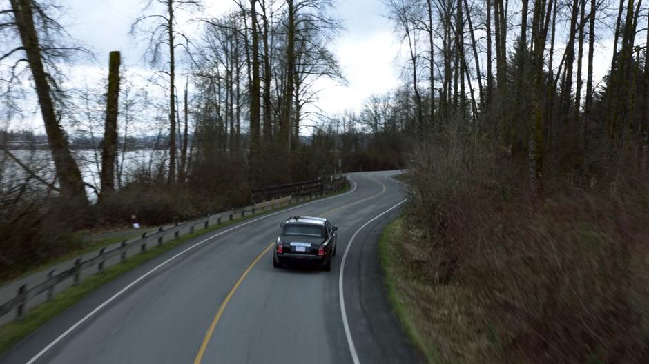 Lena's car drives around the curves on her way into town.