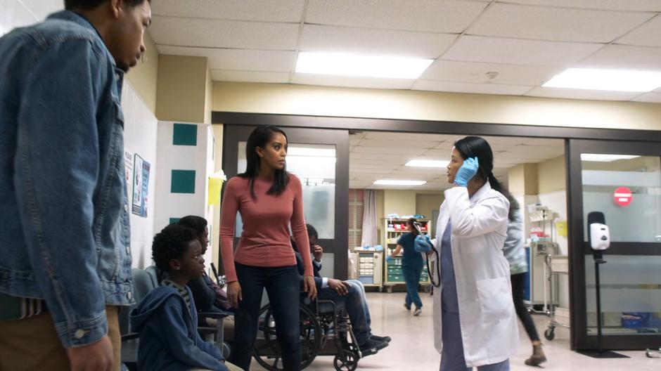 Orlando, Joey, and Kelly listen to a doctor in the hospital waiting room.