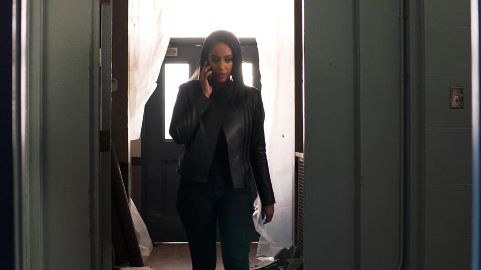 Kelly makes a phone call as she enters the basement.