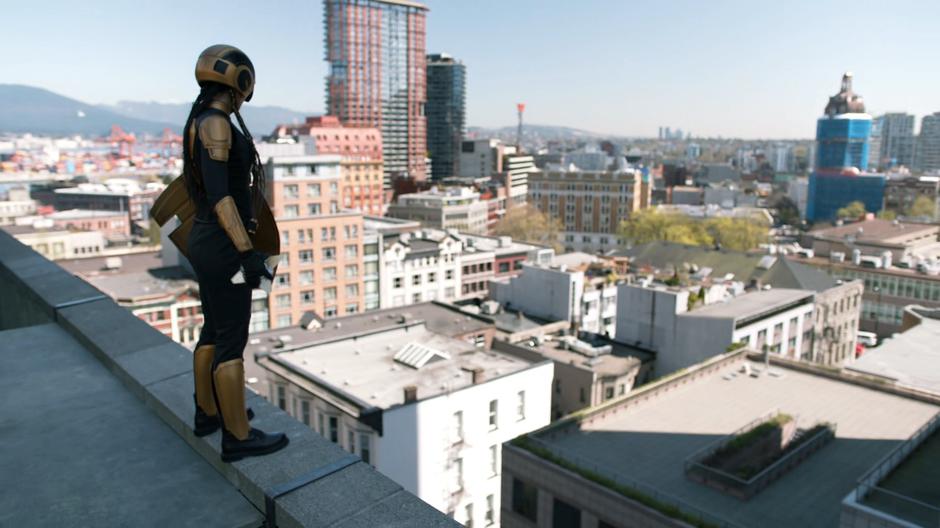 Kelly stands on the rooftop in her new Guardian suit and prepares to redirect the energy back to the people of the Heights.
