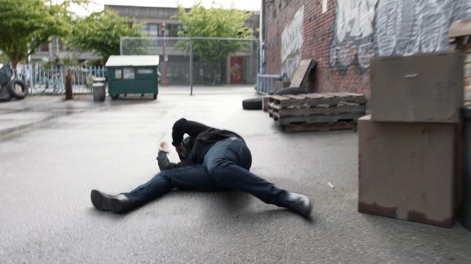 The mugger falls to the ground after being poinked in the face by the bullet thrown back by Kara.