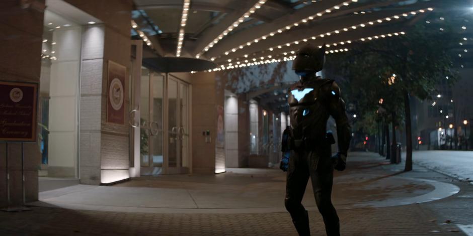 Luke stands outside the theater in his new suit.