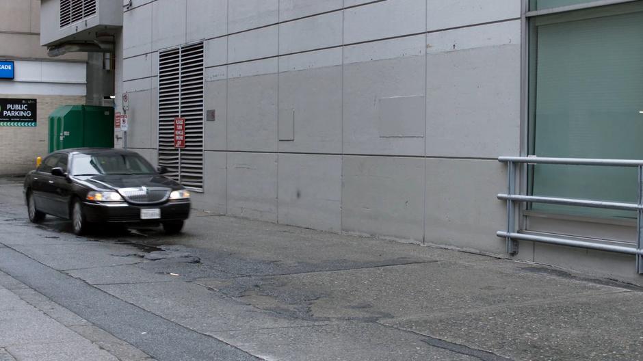 A driver speeds down an alley without watching where they are going.