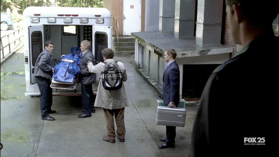 Walter supervises Greg Leiter's body being loaded into an ambulance.