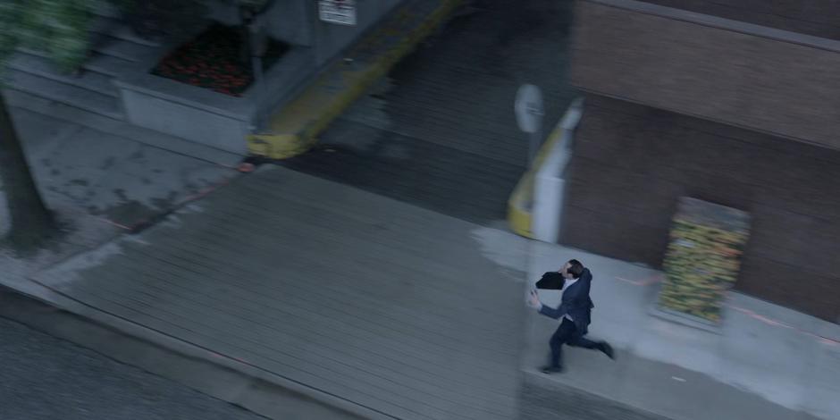 A man races down the street in an attempt to catch the bus.