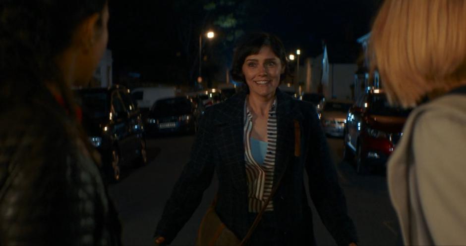 Claire runs up with a smile and greets Yaz and the Doctor.
