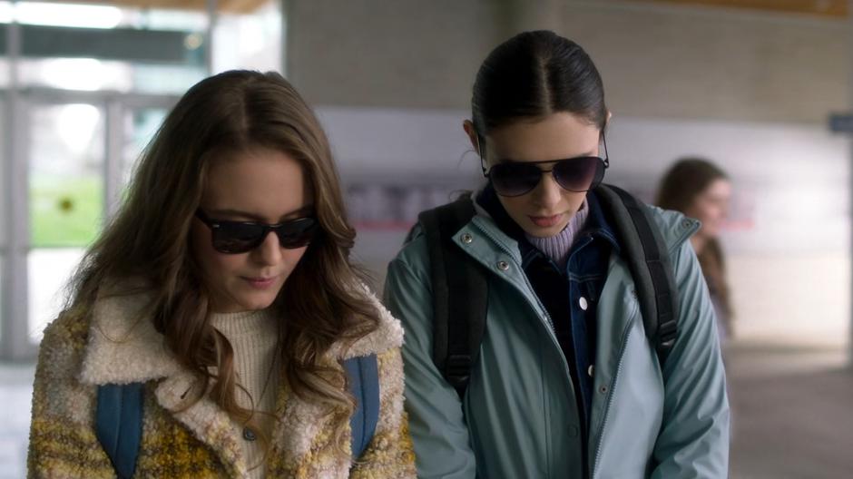 Kara and Nia try to look not suspicious while wearing sunglasses indoors.