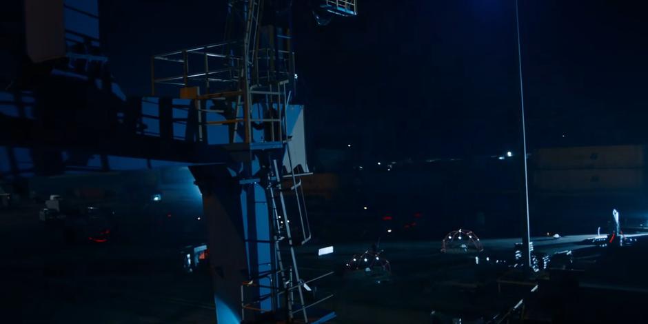 Dan climbs a ladder on the outside of one of the cranes to get to the Sontaran ship.