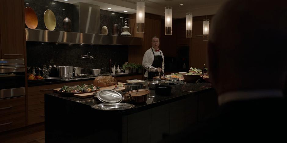 The chef turns to the butler as he is preparing dinner.