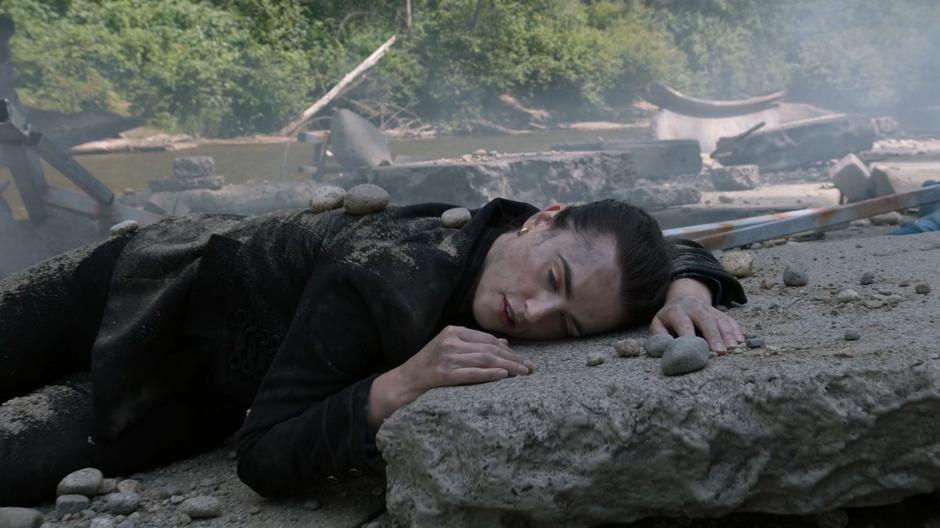 Lena wakes up from where she is lying on a piece of rubble.