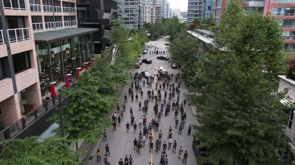 The people of National City gather in the street behind the Super Friends to support them in their fight against Lex and Nyxly.