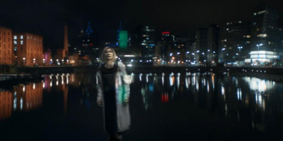 A ghostly image of the Doctor appears floating over the water.