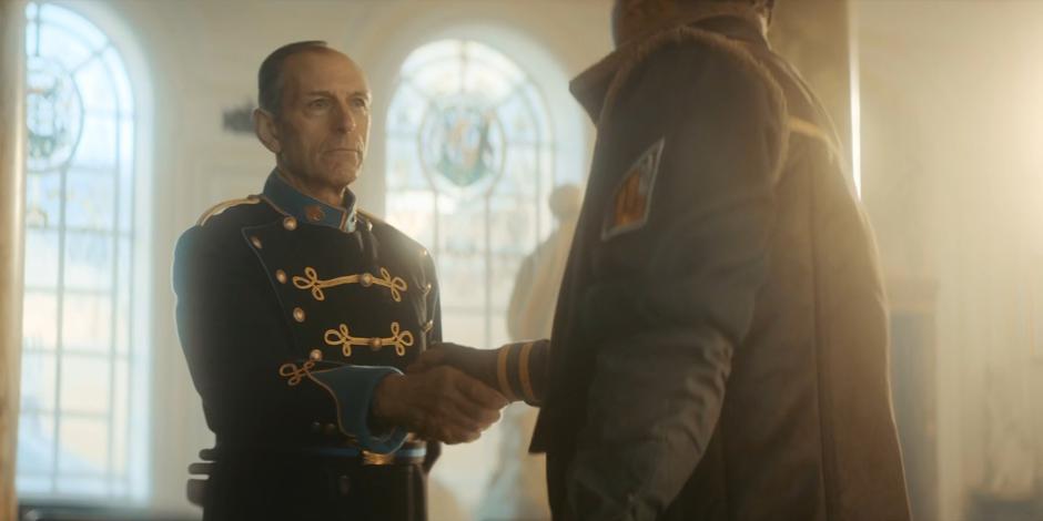 Vinder shakes the hand of his commander who was previously seen as Yaz.